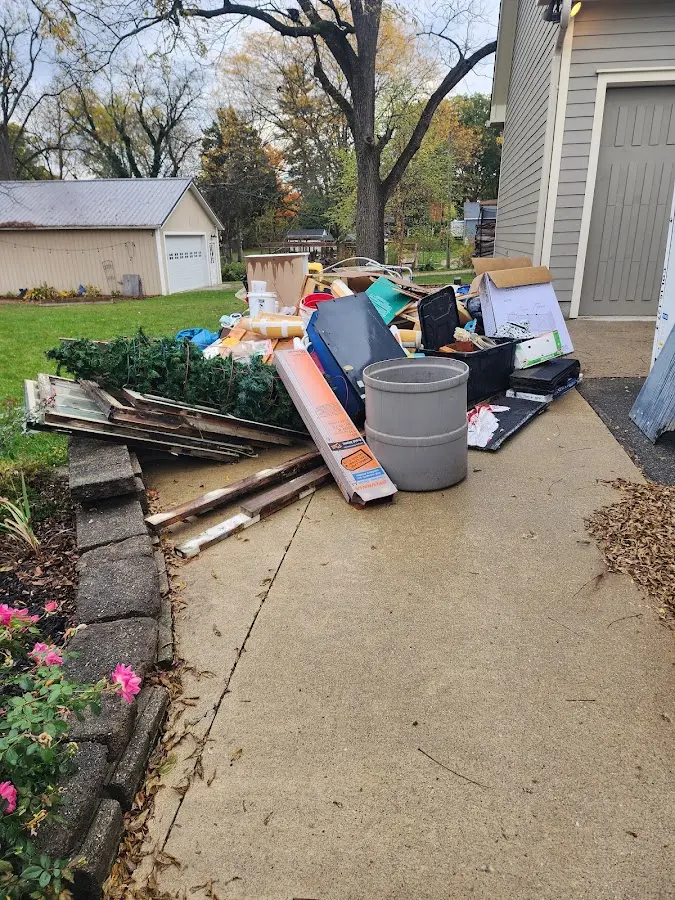 Dumpster being loaded with debris for 10 Yard Dumpster Rental in Beaumont